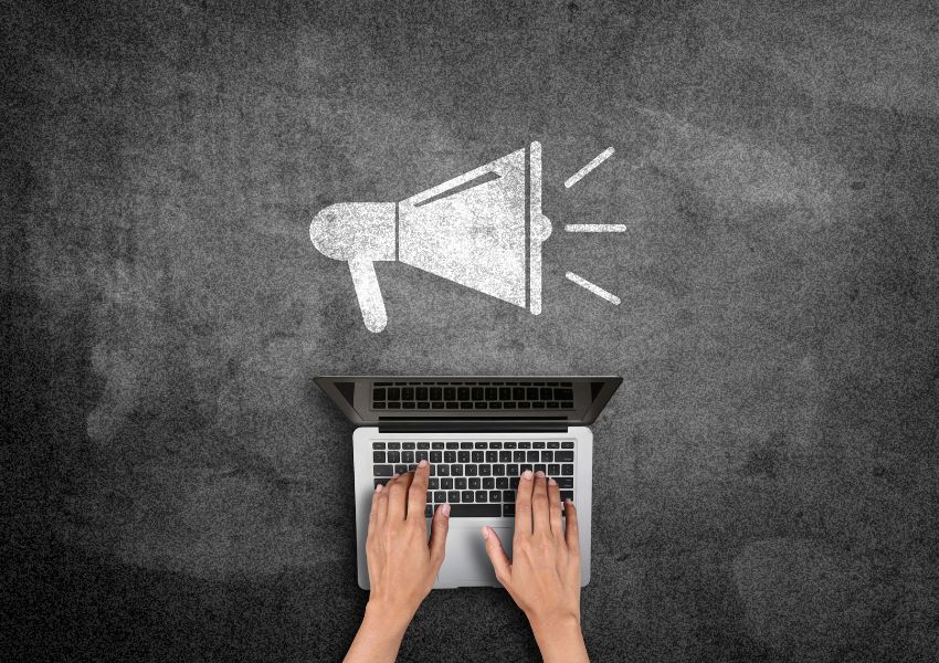 person-on-laptop-with-chalk-megaphone