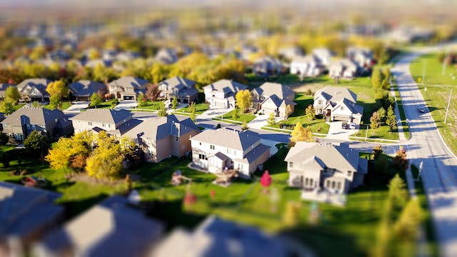 Rows of miniature suburban houses and streets.