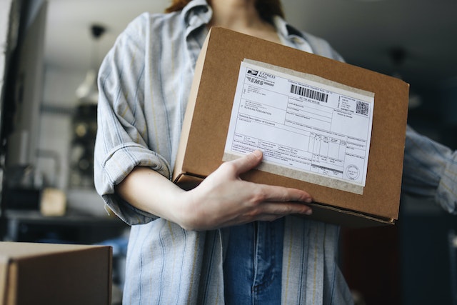 person holding brown package