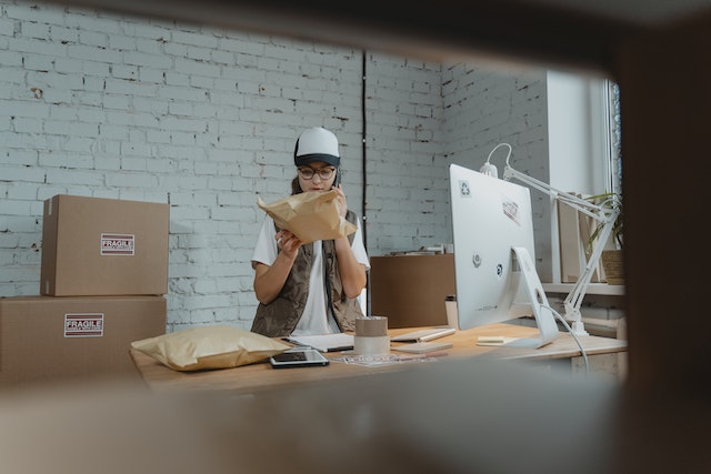 person looking at packages in a post office